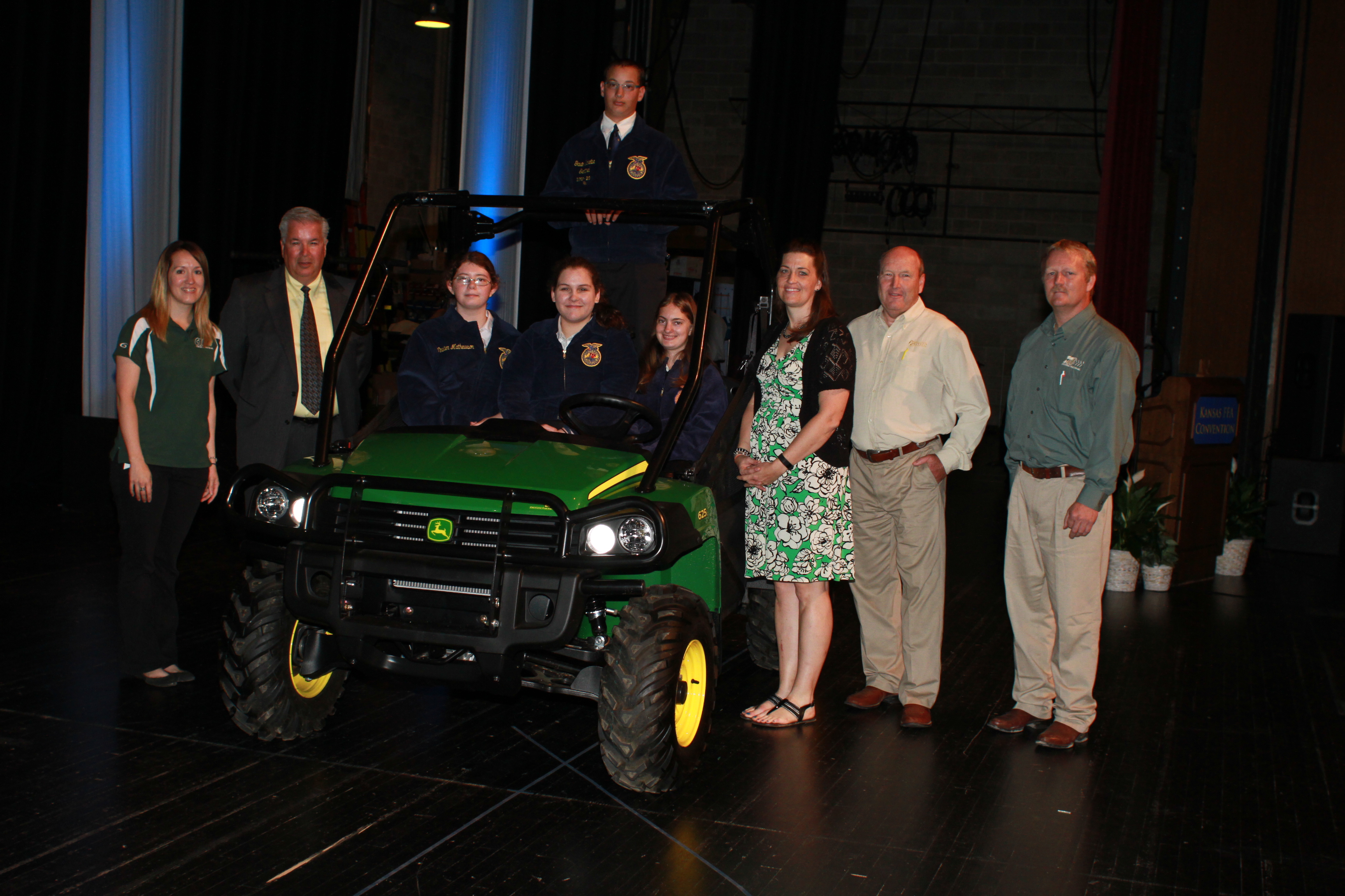 Lindsay Carpenter, Axtell FFA, sits in the driver's seat of her new John Deere Gator with members of her chapter and sponsor representatives. Sponsored by Kansas John Deere Dealers and John Deere Agriculture and Turf Division.  